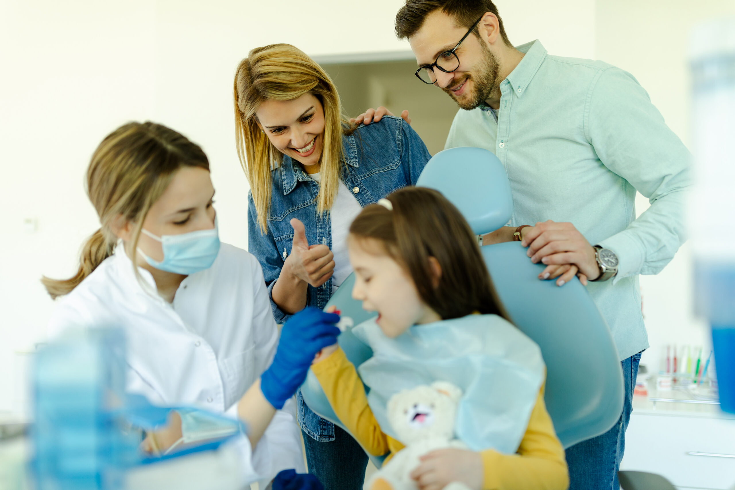 The doctor shows to girl and parents how the prost 2025 01 08 15 22 21 utc 1 scaled Young Leaders 6 preventive strategies family dentists recommend for active families