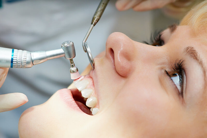 Woman at dental appointment Young Leaders 3 ways preventive dentistry supports patients with sensitive teeth